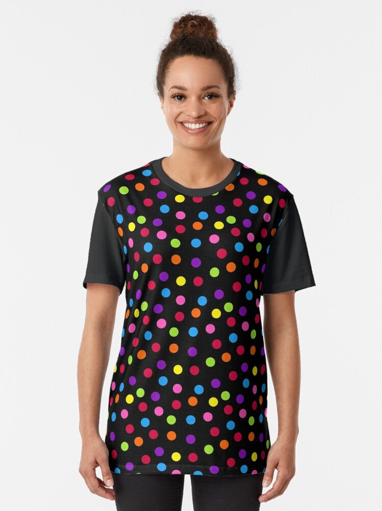 A black t-shirt with a colorful rainbow polka dot pattern graphic design. - Women