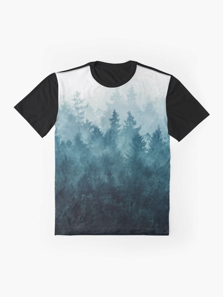 Graphic t-shirt design featuring a misty, foggy forest landscape with trees, mountains, and a blue-toned color palette - Flat lay