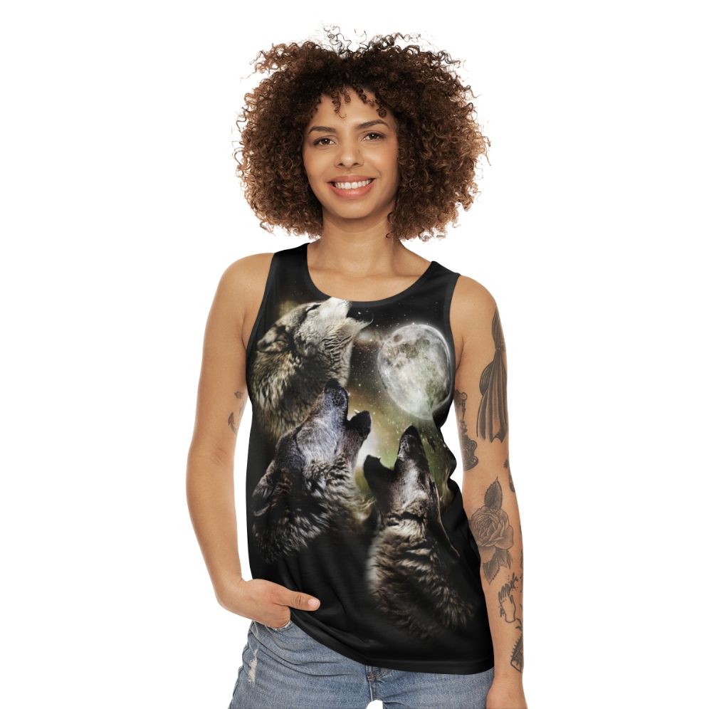 Three wolves howling at the moon on a unisex tank top - women