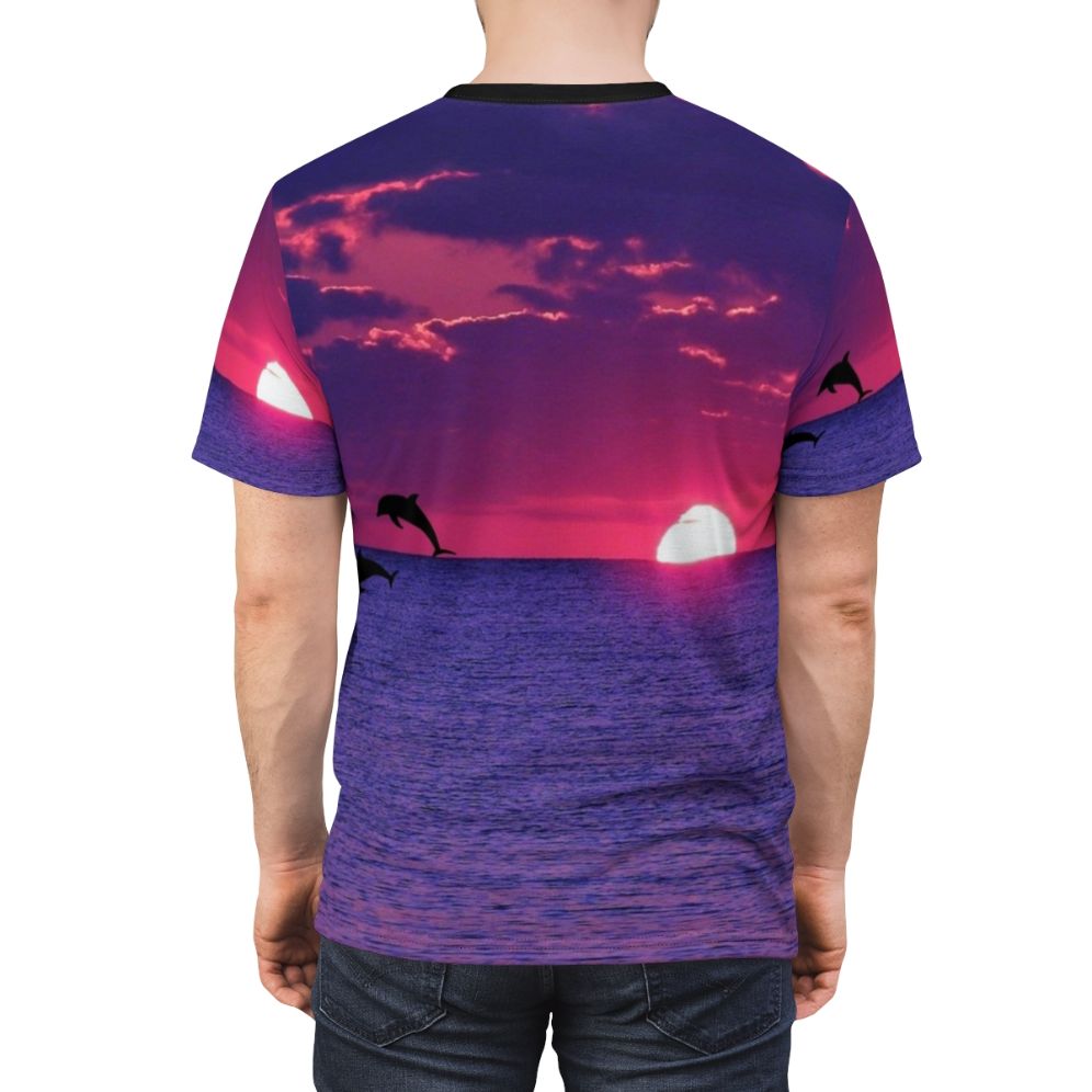 Stunning AOP t-shirt featuring a vibrant sunset sky with pink and purple hues, including a dolphin silhouette on the horizon. - men back