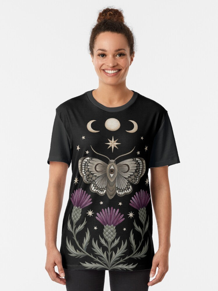 Graphic t-shirt design featuring a moth, thistle, and crescent moon with a witchy, nature-inspired aesthetic. - Women