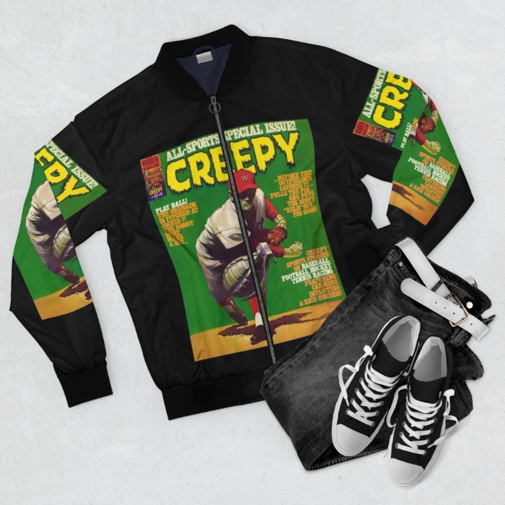 Creepy vintage horror bomber jacket with designs of monsters, vampires, and other scary elements - Flat lay