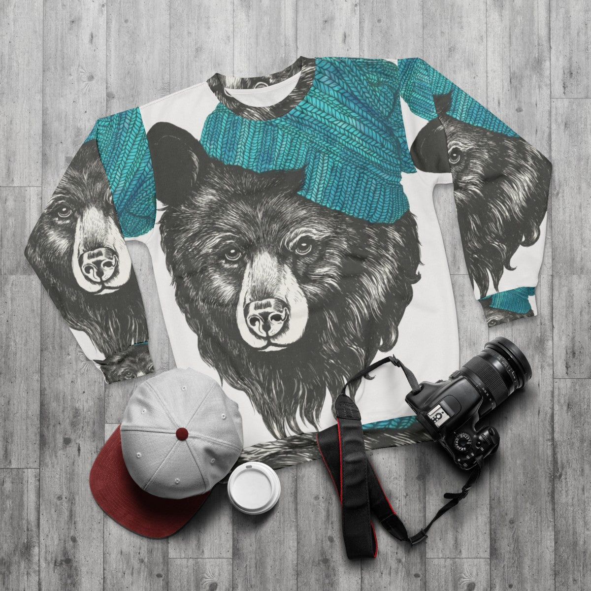 Zissou the Bear in a blue animal print sweatshirt - flat lay