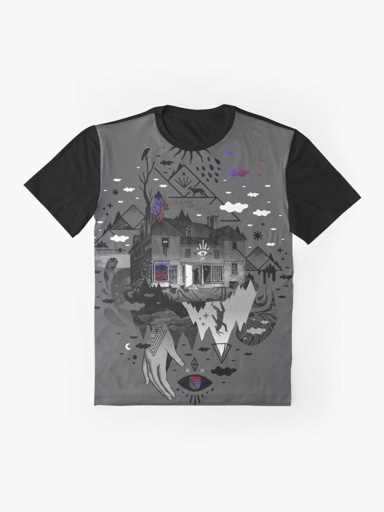 A surreal, abstract graphic tee featuring a collage-style design with a house, mountains, stars, moon, and other mystical elements. - Flat lay