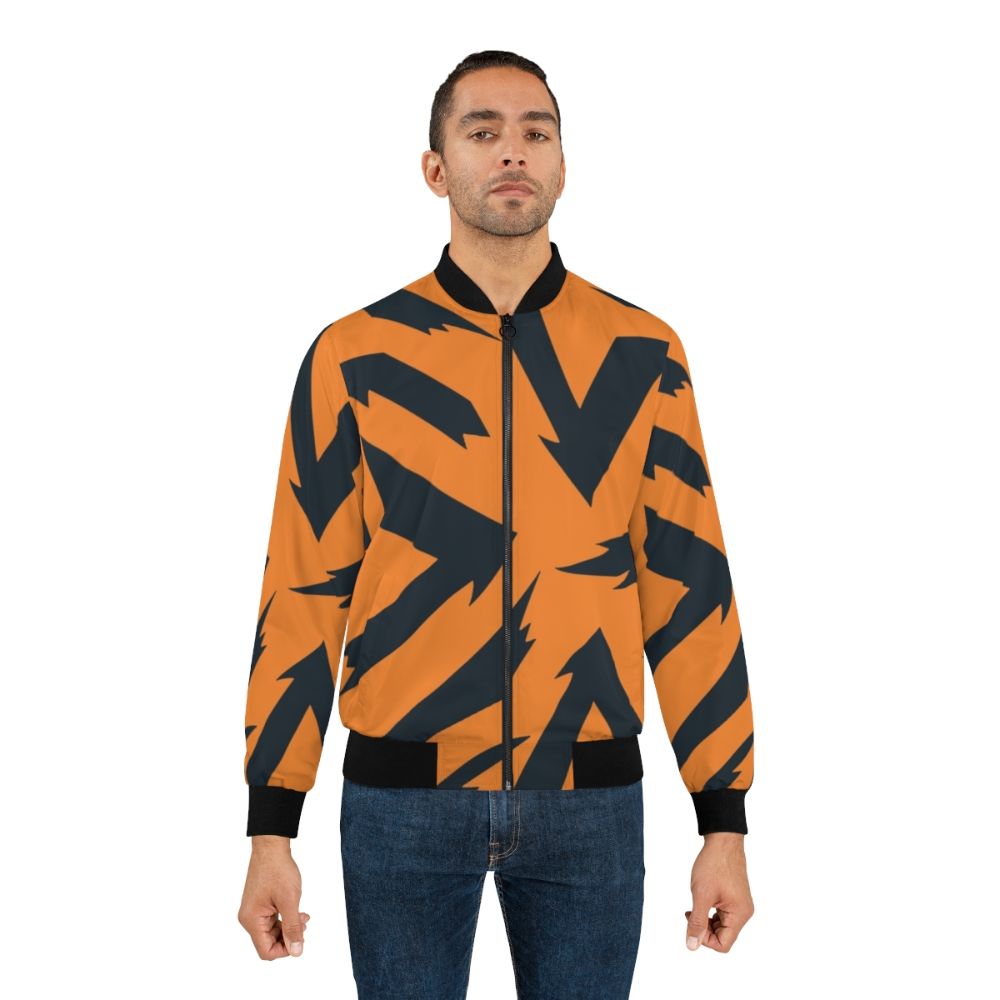 An orange and black bomber jacket with a fire-inspired pattern, featuring the Pokémon Arcanine. - Lifestyle