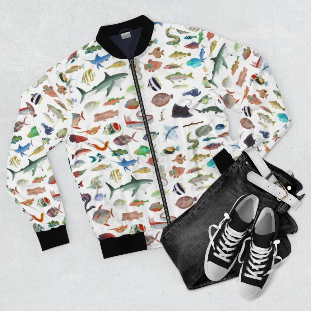 Bomber jacket featuring vibrant ocean life and marine animals like sharks - Flat lay