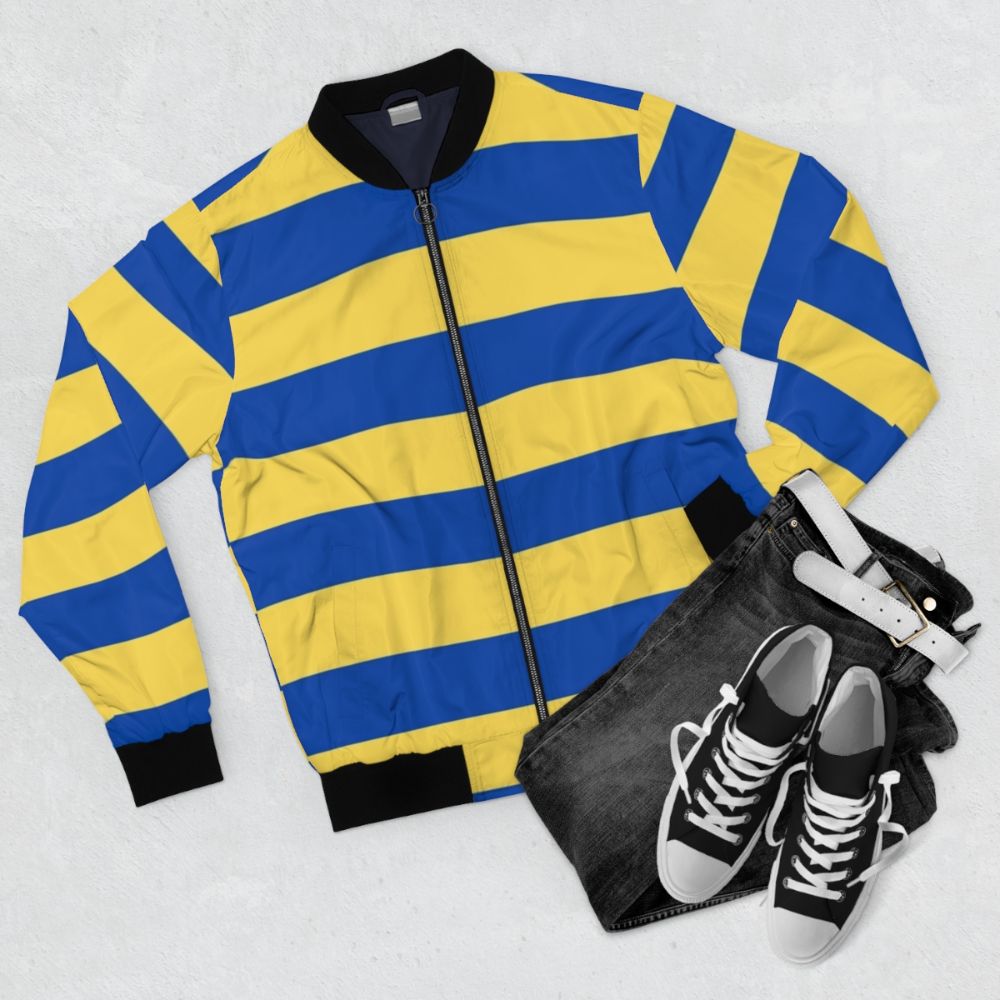 A stylish and vibrant blue and yellow striped bomber jacket - Flat lay