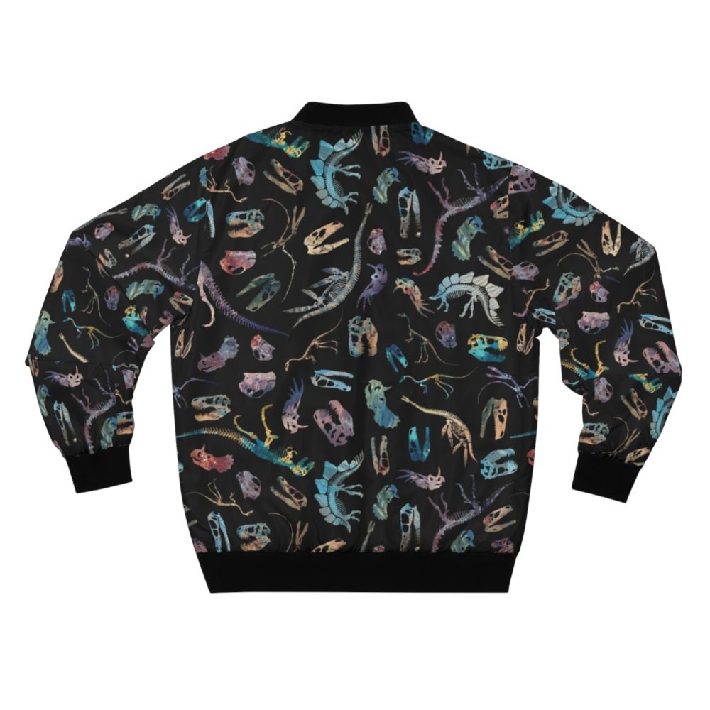 Dark bomber jacket with a dinosaur fossil and skeletal pattern design, perfect for science and paleontology enthusiasts. - Back