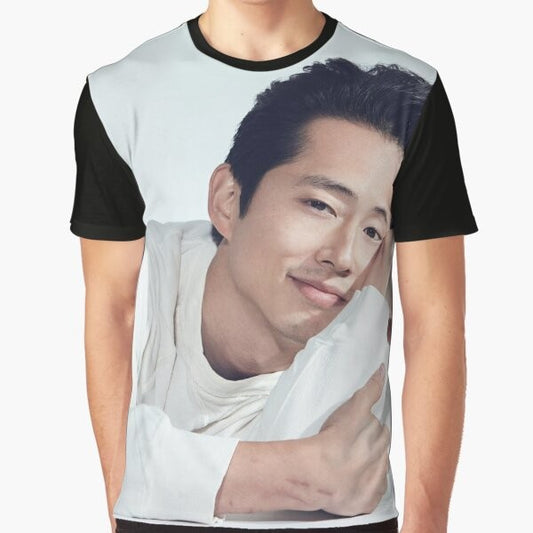 Steven Yeun, Korean actor known for The Walking Dead, wearing a graphic t-shirt