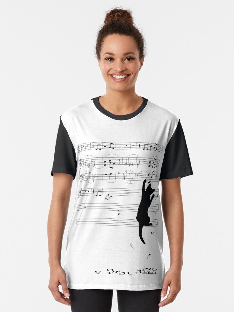 Mischievous cat silhouette playing with sheet music on a black and white graphic t-shirt design - Women