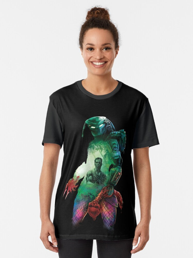 A graphic t-shirt featuring the Predator, a hunter from outer space, stalking its prey in the jungle. - Women