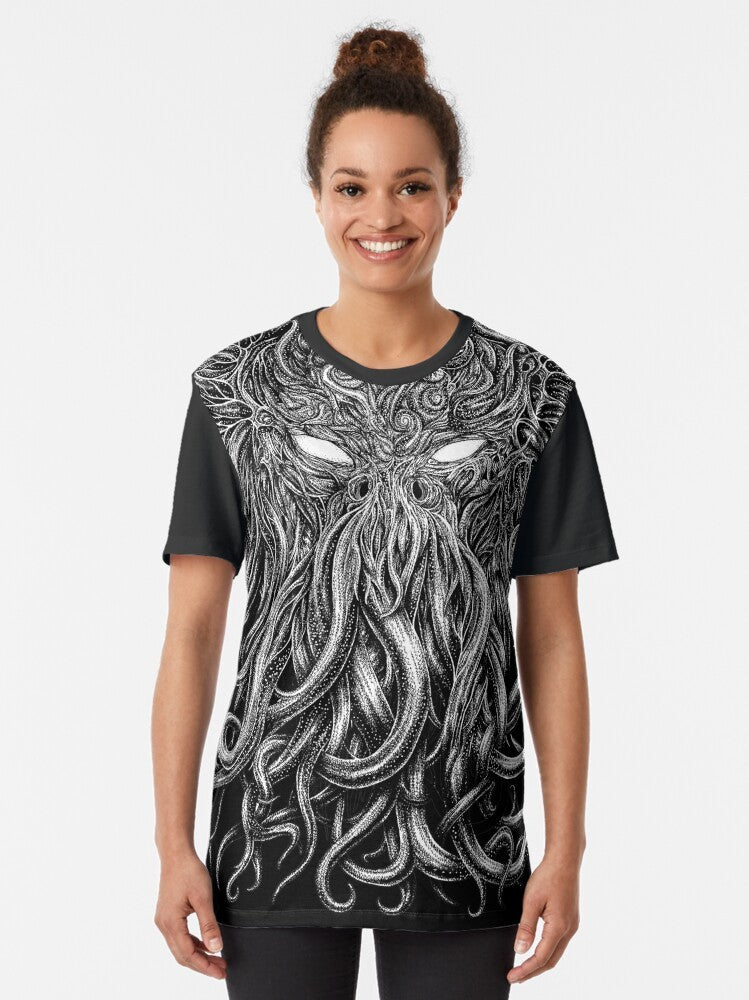 A black t-shirt featuring a graphic design of the Cthulhu creature from H.P. Lovecraft's horror stories. - Women