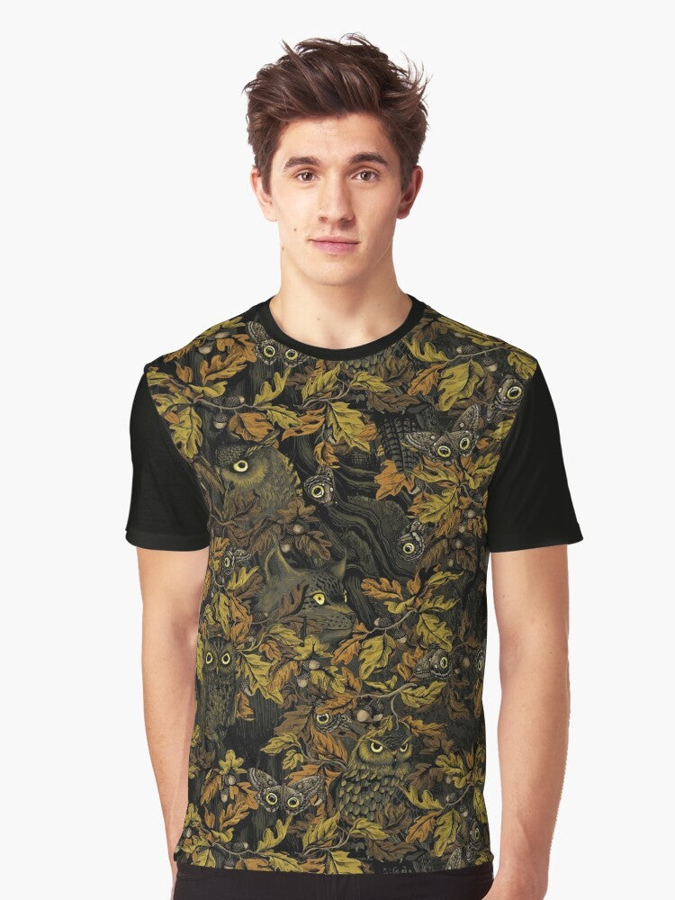 A graphic t-shirt featuring an owl design with autumn leaves, camouflage, and forest elements. - Men