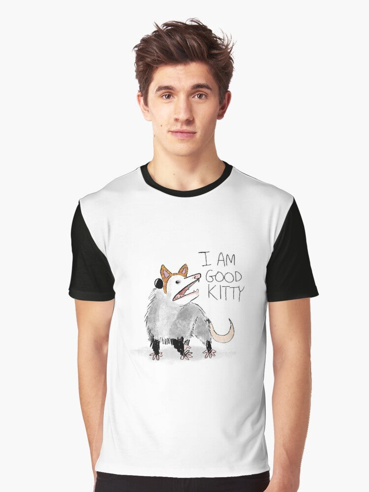 A graphic t-shirt with the text "I AM GOOD KITTY" and an opossum or possum design. - Men