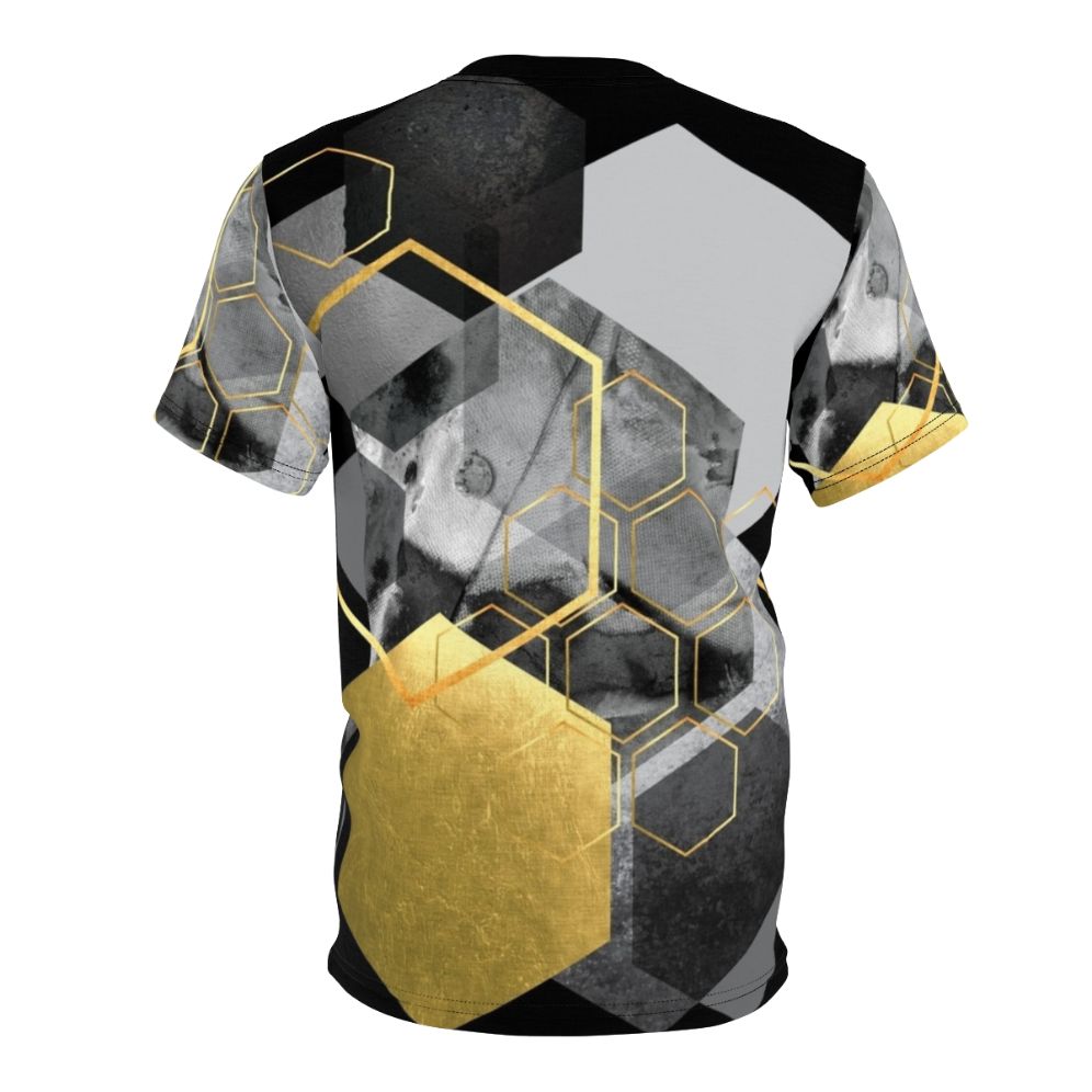 Closeup of a modern, minimalist t-shirt featuring a geometric hexagon collage design in black, white, and gold tones. - Back