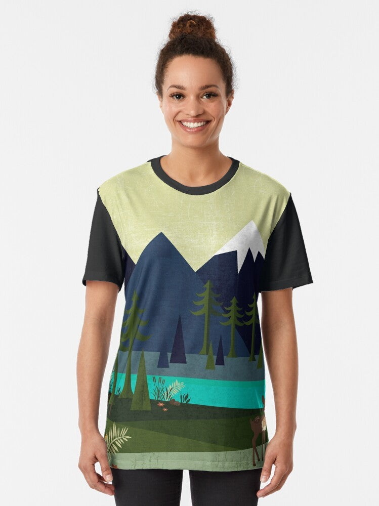 Graphic t-shirt featuring a peaceful landscape with deer, trees, and a river - Women