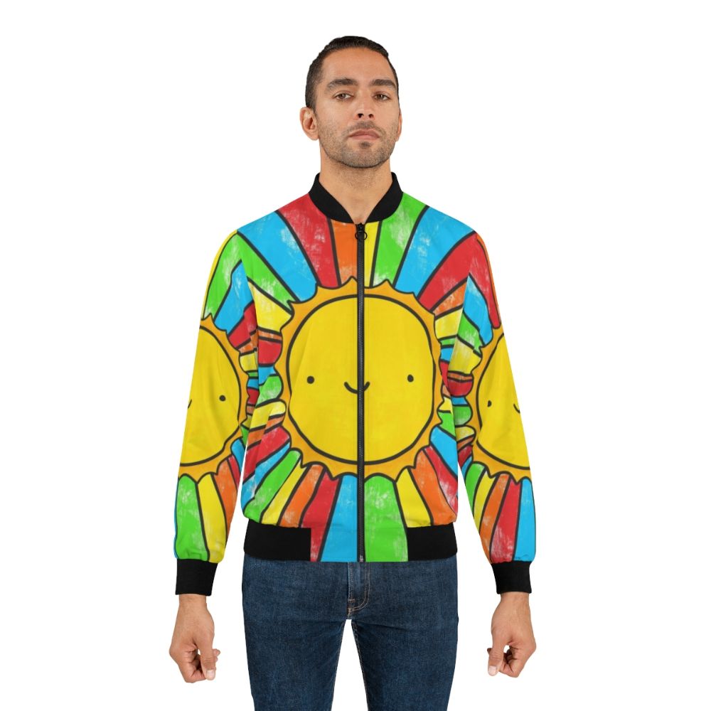 A colorful bomber jacket with a radiant sunshine, rainbows, and a positive quote to spread happiness and positivity. - Lifestyle