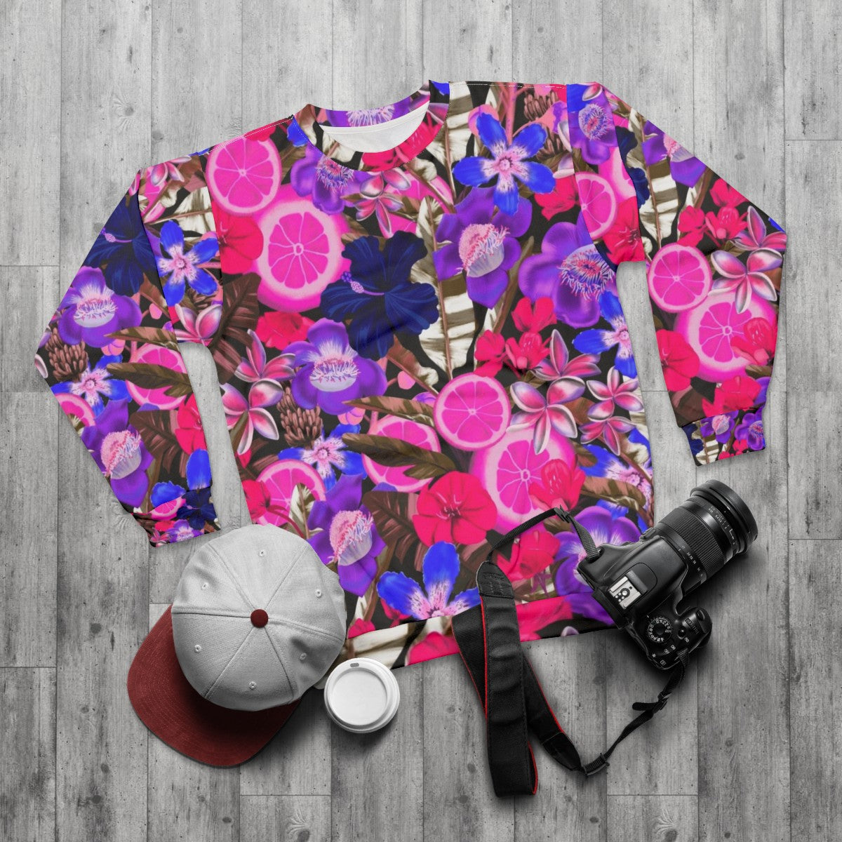 Blue sweatshirt with a colorful botanical and floral pattern - flat lay