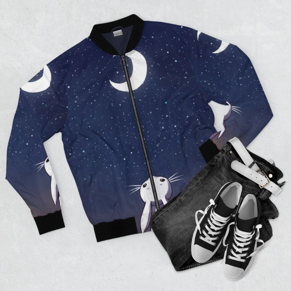 A blue children's bomber jacket with a cute bunny and moon design. - Flat lay