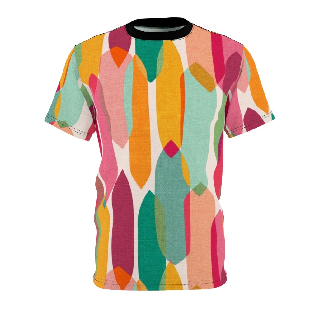 Model wearing a t-shirt featuring a vibrant mid century modern inspired abstract droplet pattern in a colorful kaleidoscope design