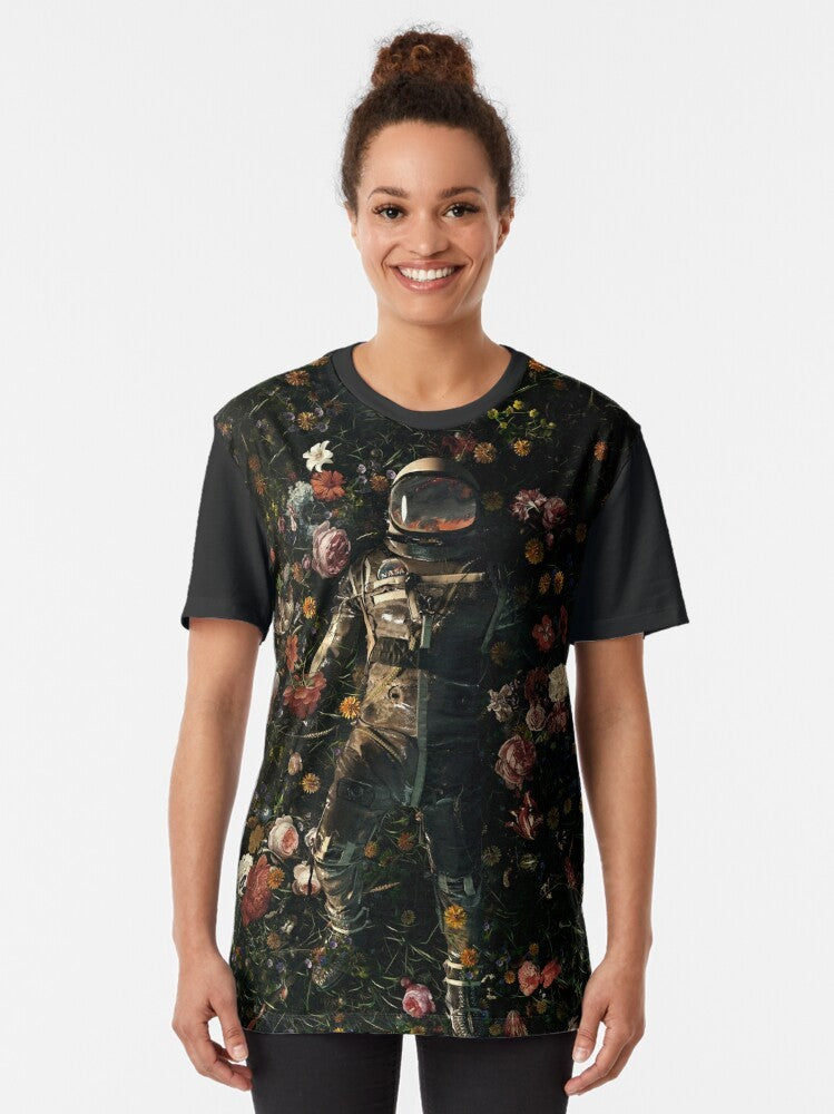 Interstellar Floral Graphic T-Shirt featuring a surreal design with flowers, space, and cosmic elements. - Women