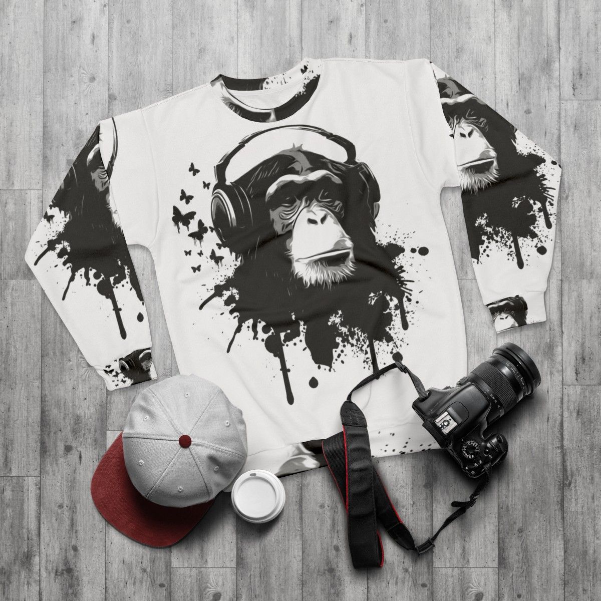 Stylish monkey business sweatshirt with vibrant splatter pattern and animal graphics - flat lay