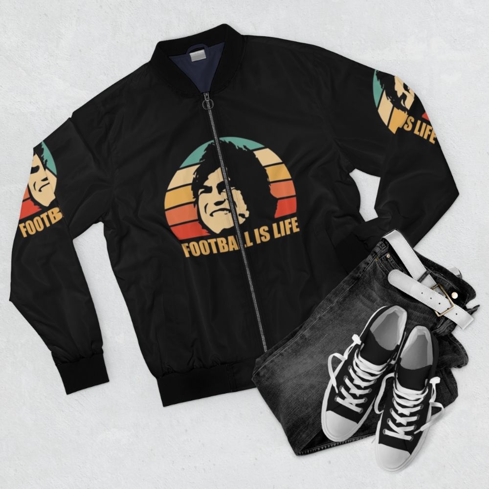 Football is Life Bomber Jacket featuring a quote and design inspired by the TV show Ted Lasso - Flat lay