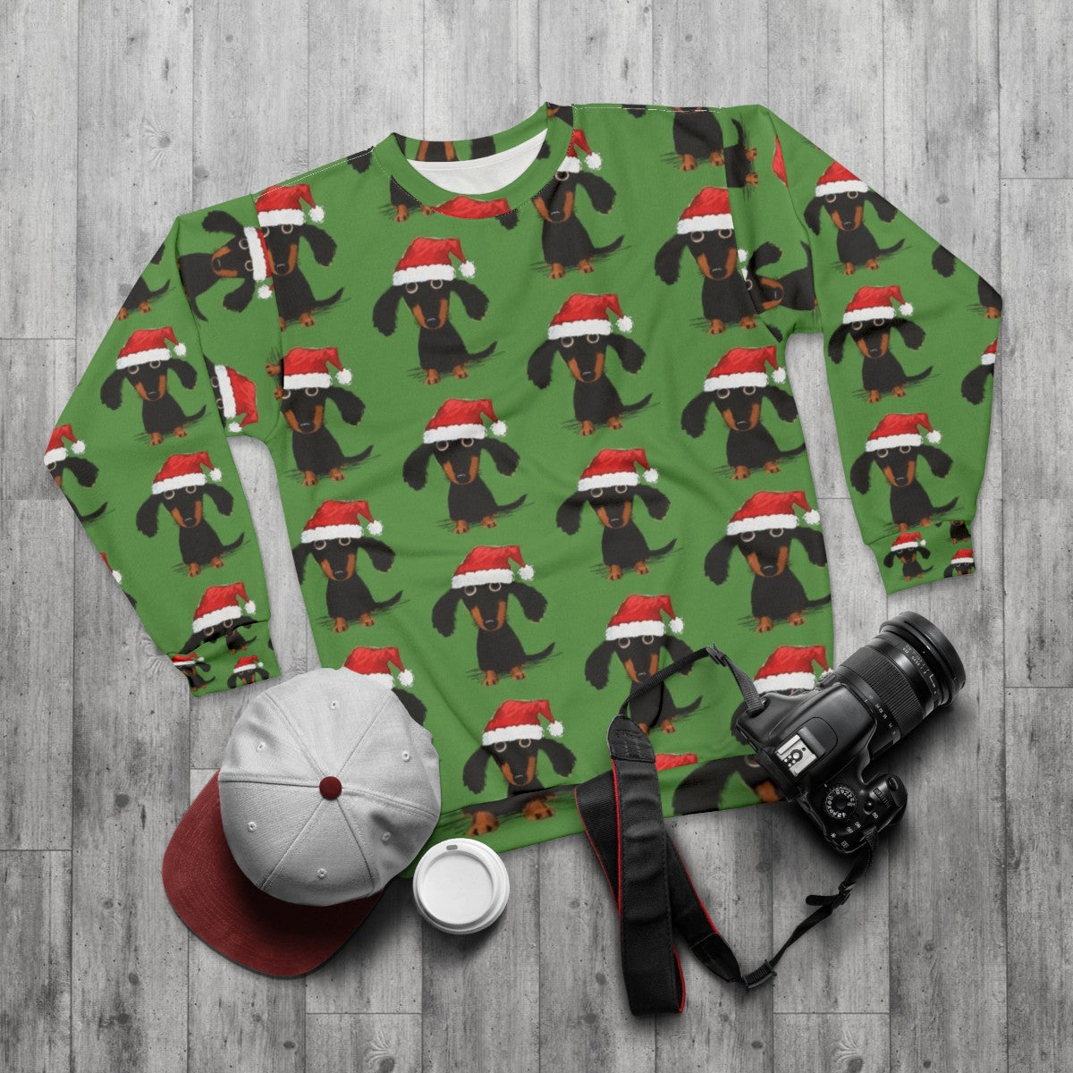 A cozy and humorous Christmas sweatshirt featuring a dachshund dressed as Santa - flat lay