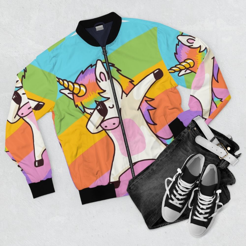 A stylish bomber jacket featuring a dabbing unicorn design with hip hop and dab elements. - Flat lay