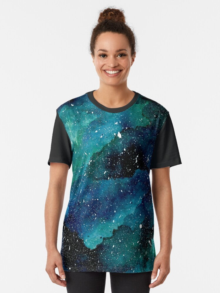 Emerald Galaxy Graphic T-Shirt featuring a colorful, watercolor-inspired design of the galaxy, stars, and planets. - Women