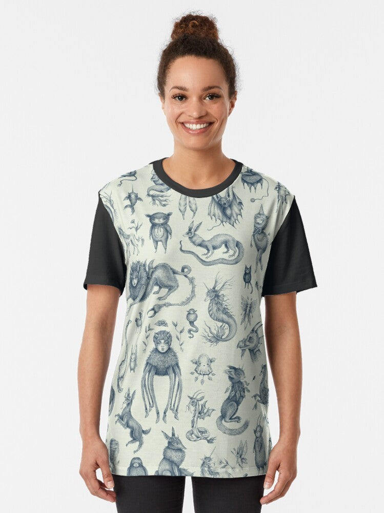 Graphic t-shirt featuring pastel-colored illustrations of mythical creatures like nessie, bigfoot, and dragons - Women