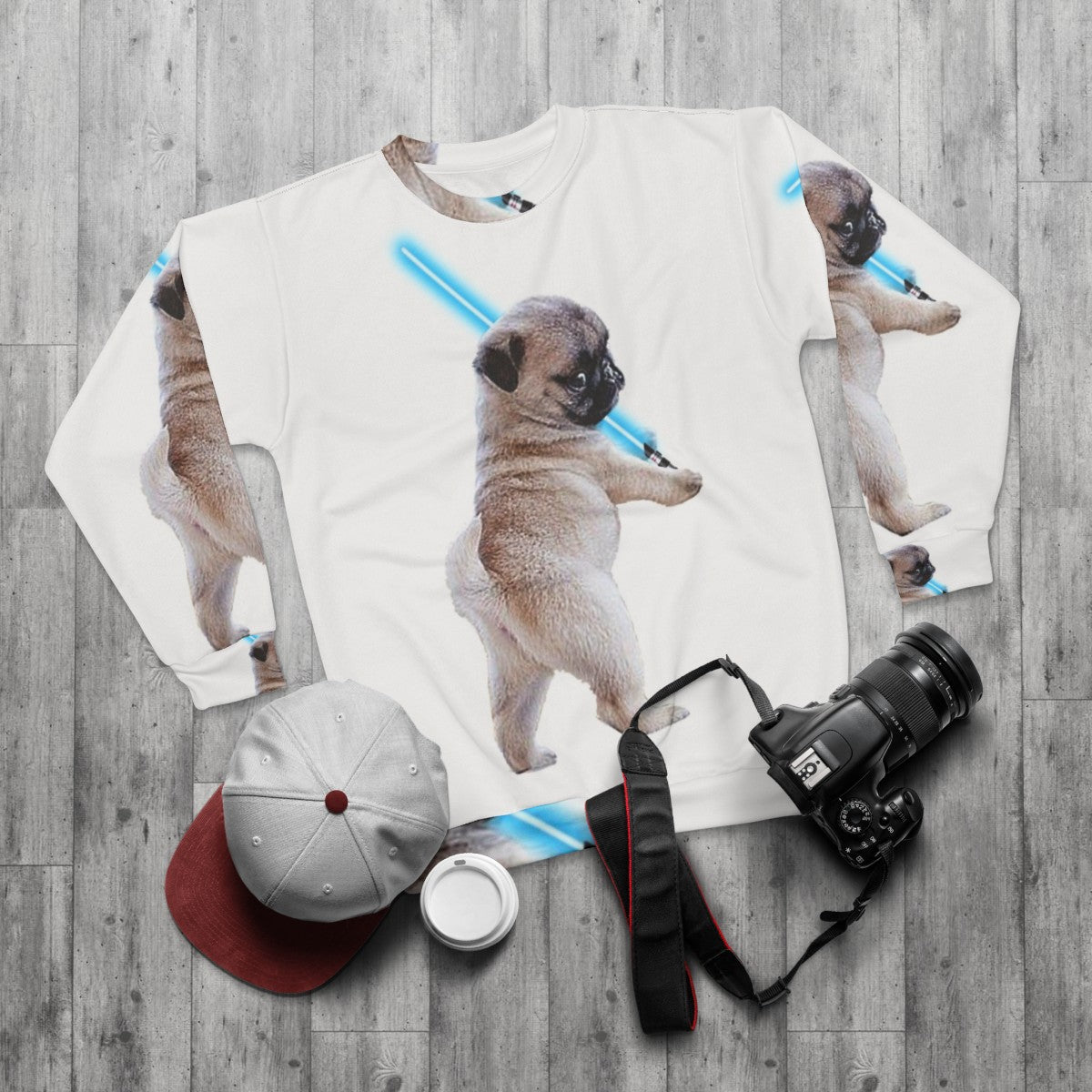 Pug wearing a sweatshirt with a lightsaber graphic - flat lay