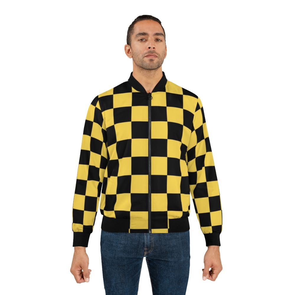 A black and yellow checkered bomber jacket with a geometric, patterned design. - Lifestyle