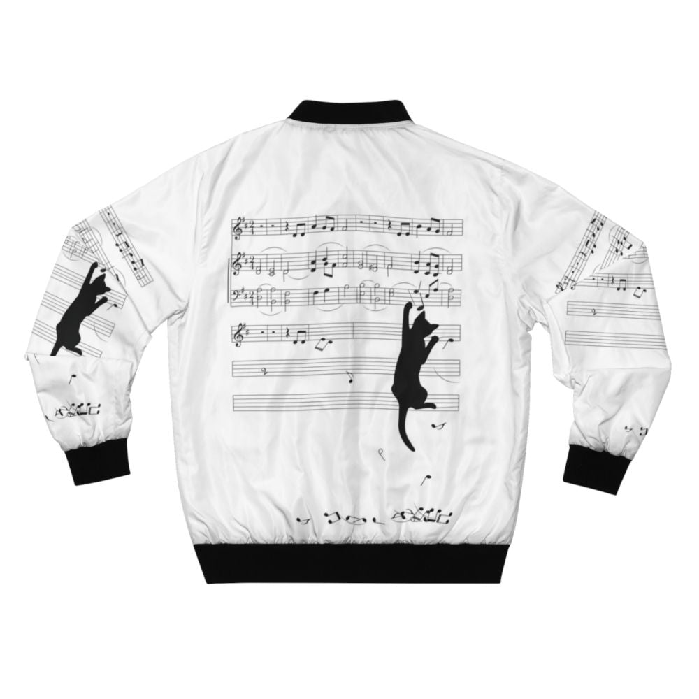 A black and white bomber jacket with a surreal design of a cat playing with sheet music and musical notes, showcasing a mischievous and playful nature. - Back