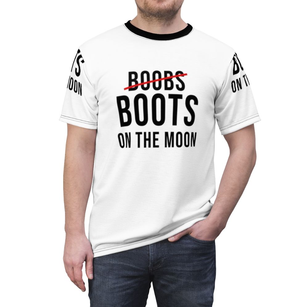 Graphic t-shirt design featuring an out-of-this-world image of boobs and boots on the moon - men front