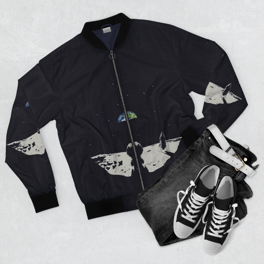 Kerbal space program-inspired bomber jacket with design elements including rockets, spacecraft, and the Kerbal logo - Flat lay