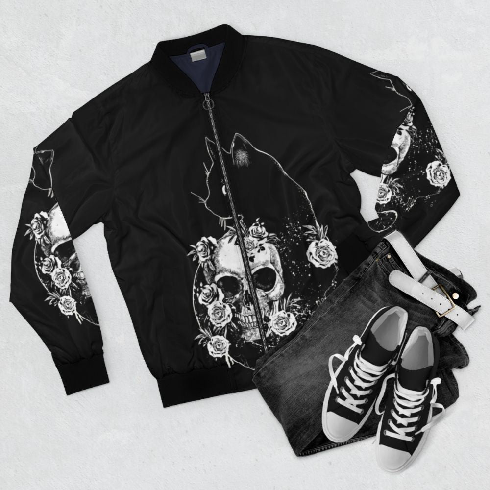 Bomber jacket with a black cat, skeleton, and bird design in a black and white drawing style. - Flat lay