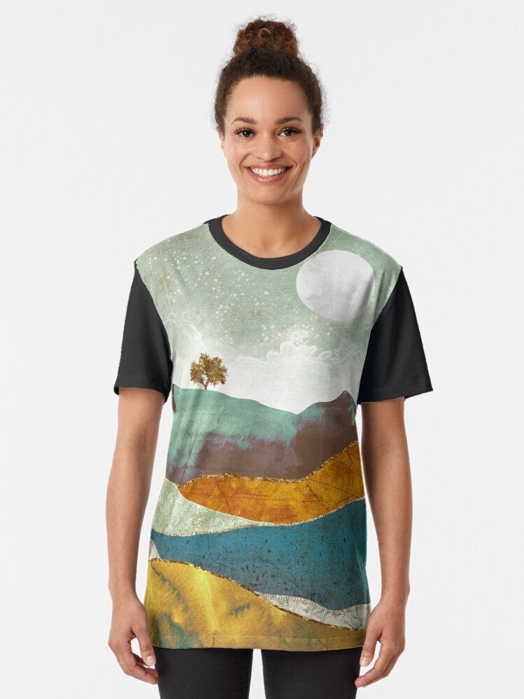 A graphic t-shirt featuring a stunning night fog landscape with a celestial atmosphere of stars, moon, and clouds. - Women