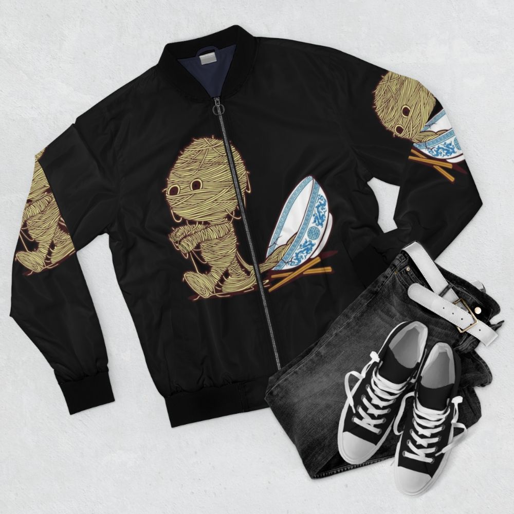 Ramen-inspired bomber jacket with chopsticks and noodle bowl graphic - Flat lay