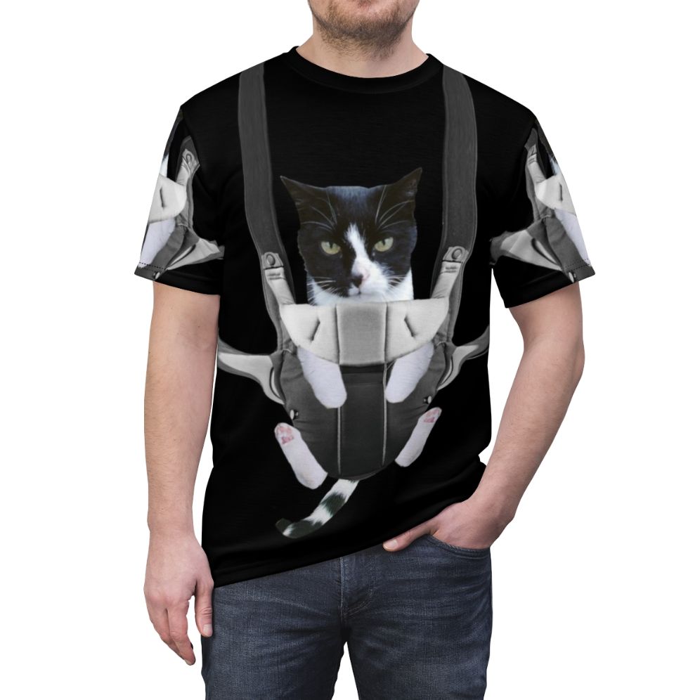 Illustration of a cat snuggled up in a baby carrier on a t-shirt - men front