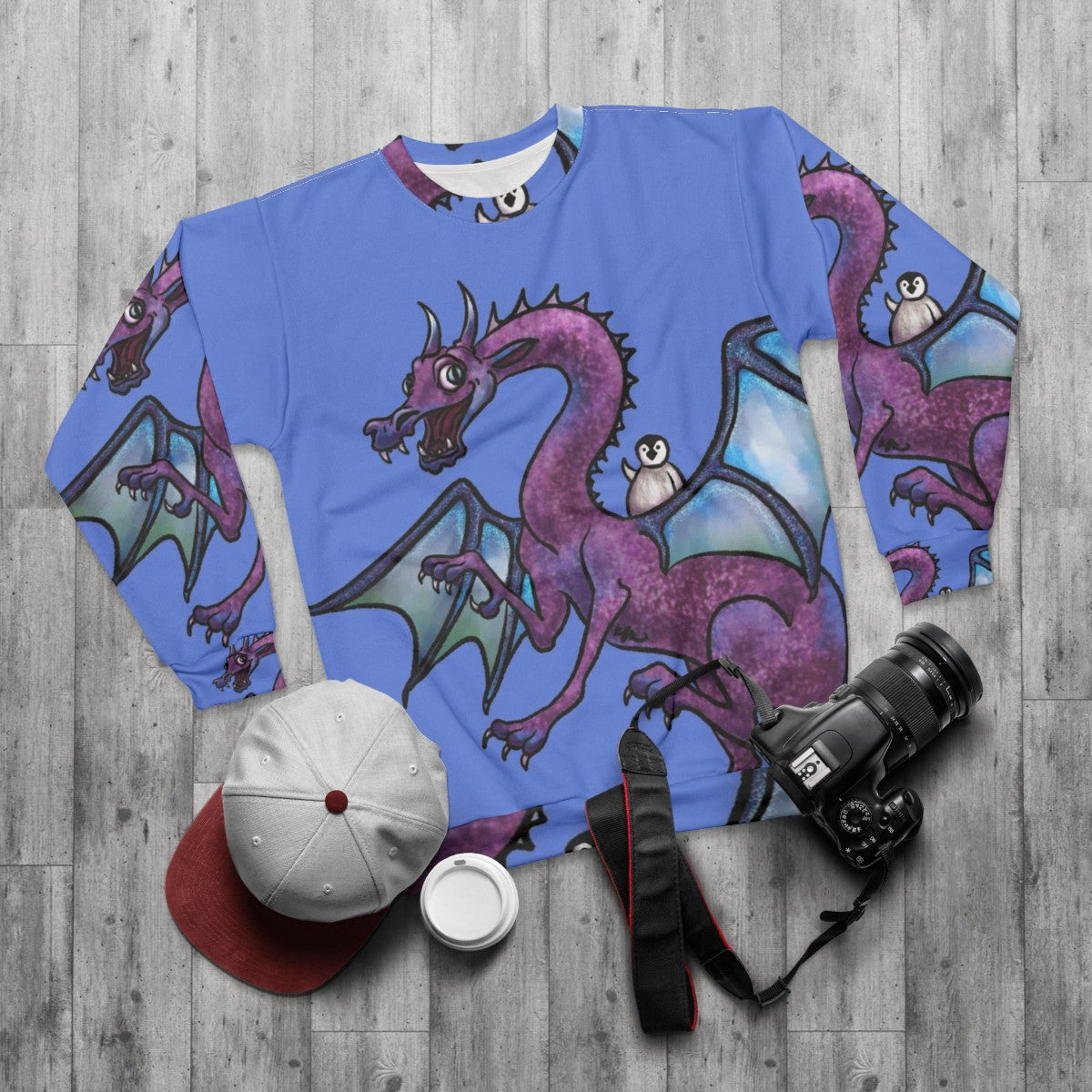 Penguin and dragon saving the day on a heroic fantasy sweatshirt - flat lay