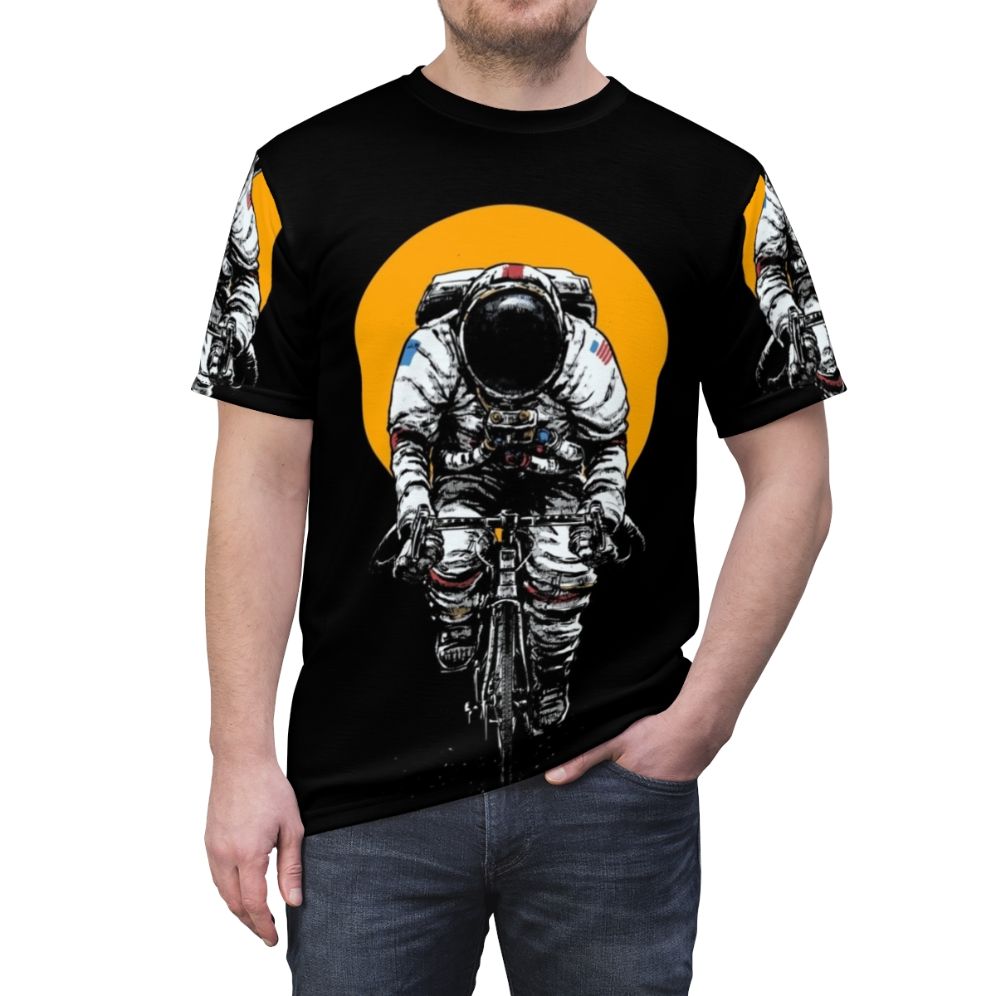 Cycling-inspired t-shirt with a space-themed design featuring an astronaut riding a bicycle in the cosmos. - men front