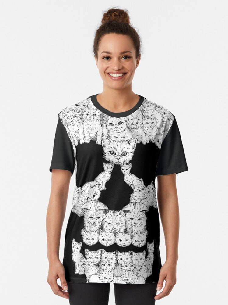 A graphic t-shirt featuring a tough-looking skull design with cute kittens. - Women