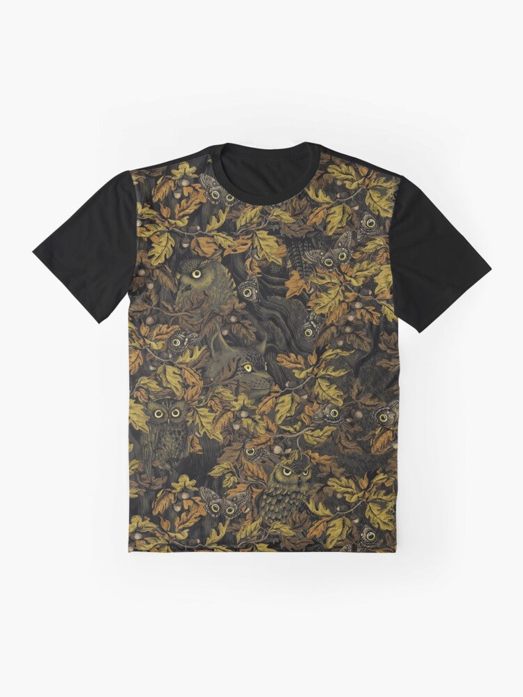 A graphic t-shirt featuring an owl design with autumn leaves, camouflage, and forest elements. - Flat lay