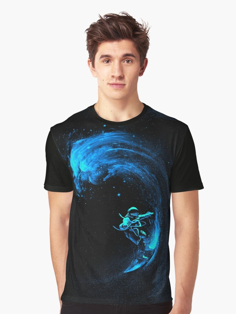 A graphic t-shirt design featuring an astronaut surfing through a colorful, cosmic galaxy filled with stars and swirling nebulas. - Men