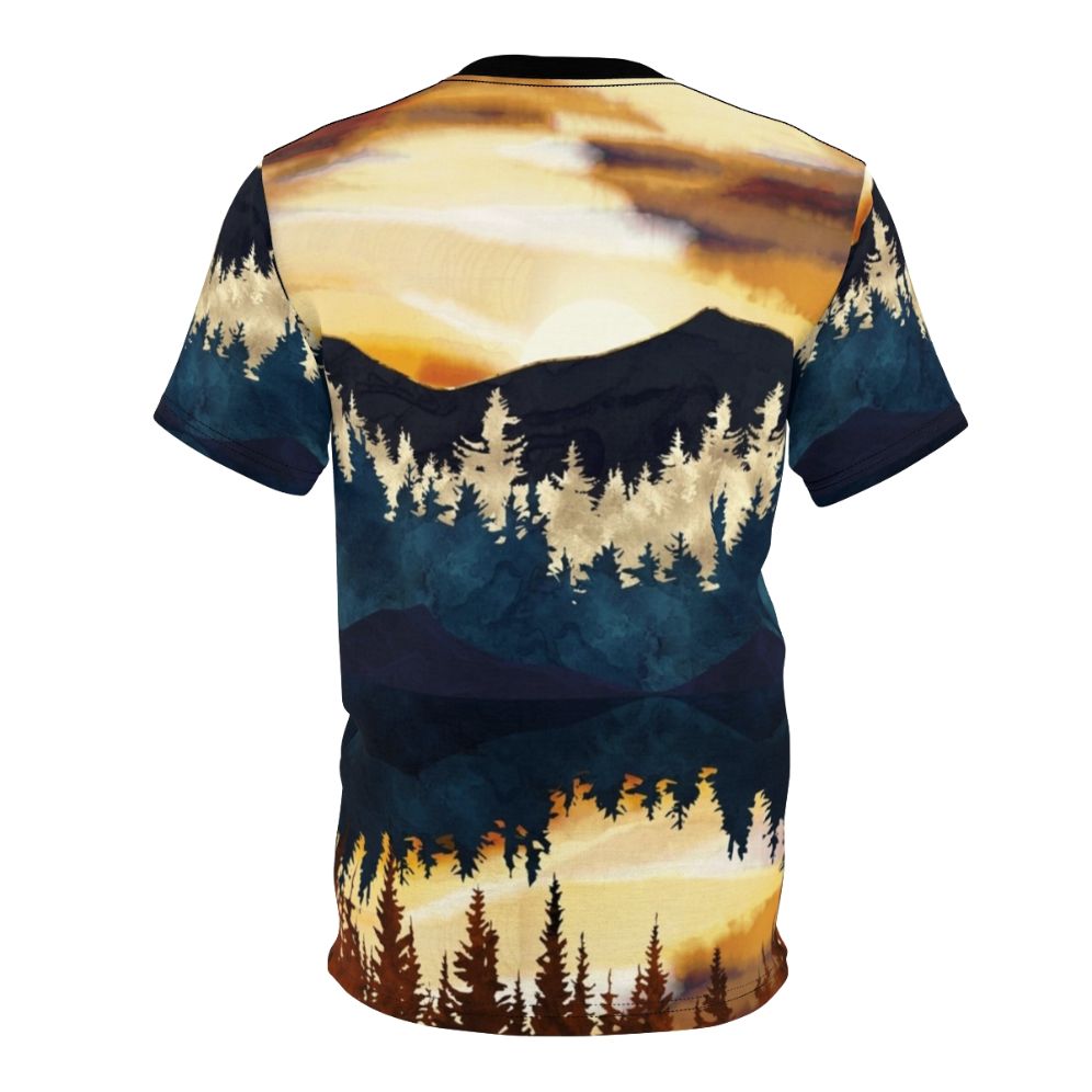 A t-shirt featuring a vibrant, watercolor-style landscape design with a beautiful fall sunset over a lake, surrounded by forests and mountains. - Back