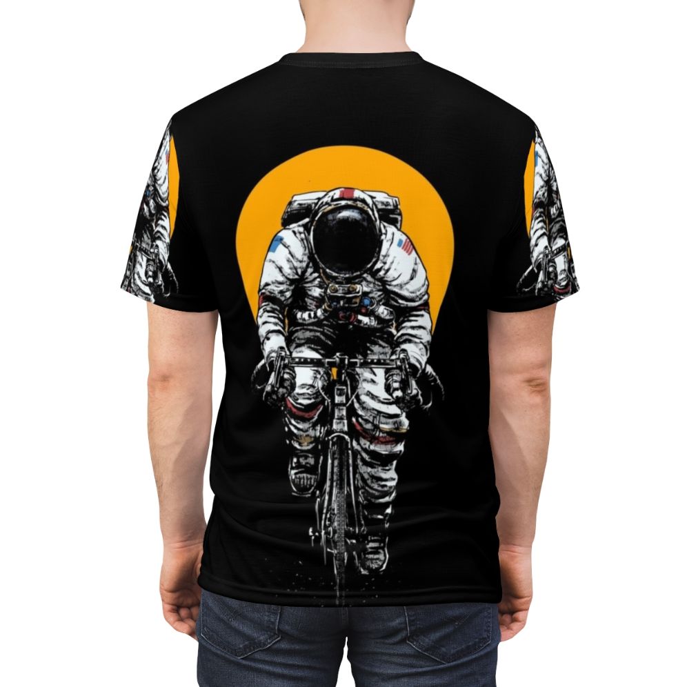 Cycling-inspired t-shirt with a space-themed design featuring an astronaut riding a bicycle in the cosmos. - men back