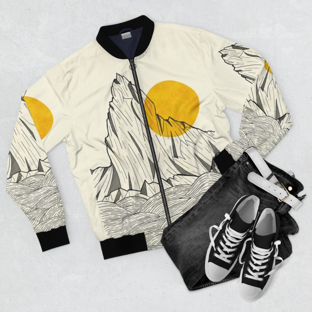 A stylish bomber jacket featuring an abstract design inspired by sea cliffs, mountains, and the natural world. - Flat lay