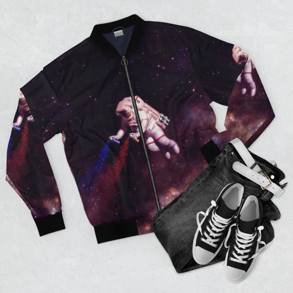 Colorful galaxy-themed bomber jacket with astronaut and spray paint design - Flat lay