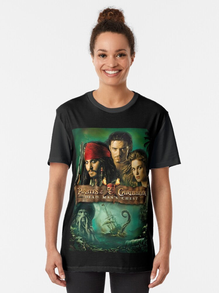 A graphic t-shirt featuring the iconic characters and imagery from the movie "Pirates of the Caribbean: Dead Man's Chest", including Jack Sparrow, the Black Pearl, and the Caribbean setting. - Women